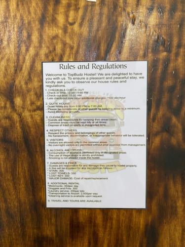 a piece of paper on a wooden table at Moalboal Panagsama beach TopBudz Hostel in Moalboal