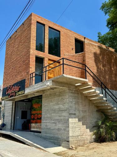 ein Backsteingebäude mit einer Seitentreppe in der Unterkunft Modern loft with AC Close to downtown Huatulco in Santa María Huatulco