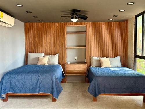 Ein Bett oder Betten in einem Zimmer der Unterkunft Modern loft with AC Close to downtown Huatulco