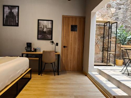 a bedroom with a bed and a desk and a door at Hacienda Álamos in Laborcillas