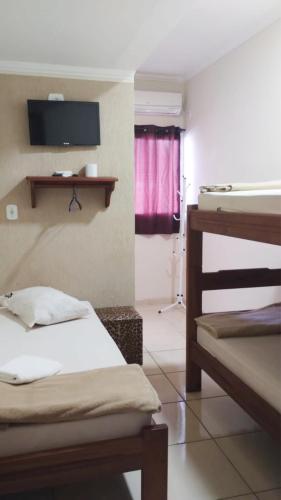 Ένα ή περισσότερα κρεβάτια σε δωμάτιο στο Hotel pousada estação dos devotos