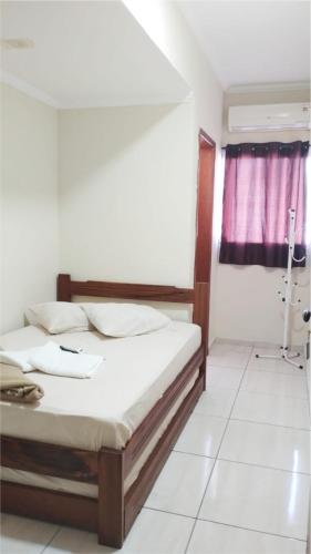 Ένα ή περισσότερα κρεβάτια σε δωμάτιο στο Hotel pousada estação dos devotos