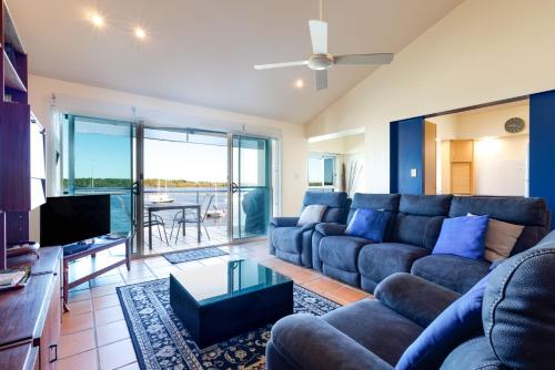 a living room with a couch and a tv at Riverview Apartment 2.6 3-5 Riverview Street in Iluka