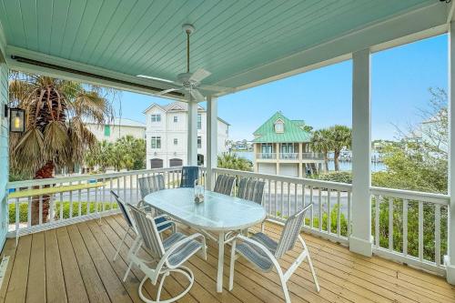 a patio with a table and chairs on a deck at Sandy Gull Too in Orange Beach