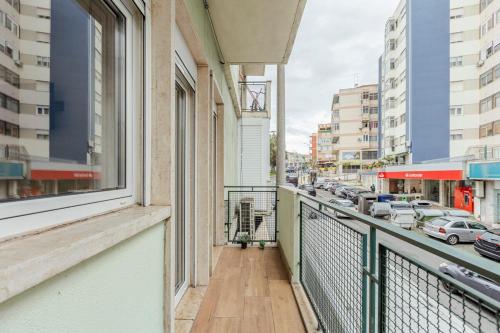 a balcony with a view of a city street at 2-bedroom gem Central Odivelas in Odivelas