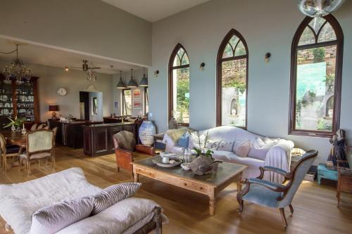 a living room with white furniture and a table at House of Rogues in Tortola Island