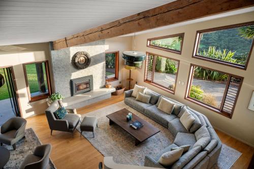 a living room with a couch and a fireplace at Villa Rangihoua in Omiha