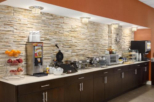 a kitchen with a counter with a brick wall at Country Inn & Suites by Radisson Nashville Airport TN in Nashville