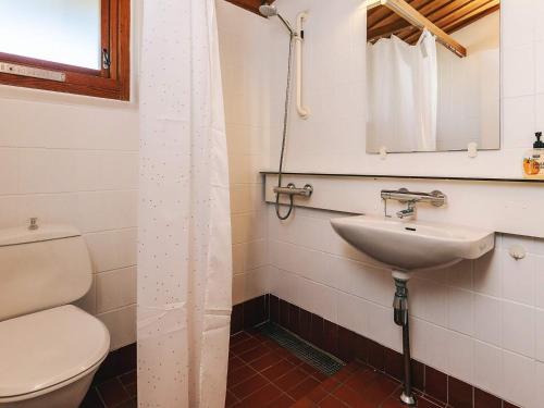 a bathroom with a toilet and a sink at Holiday home on a holiday park in Gilleleje in Gilleleje