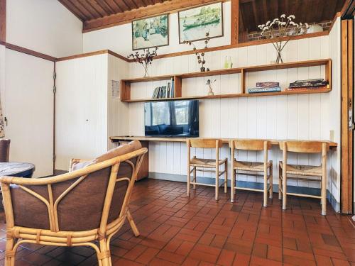 a dining room with a table and chairs at Holiday home on a holiday park in Gilleleje in Gilleleje