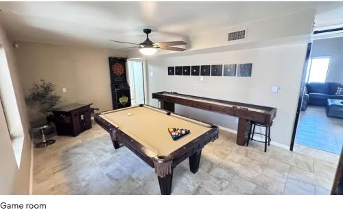 a living room with a pool table and a piano at Best Riverfront Parker Home in Parker