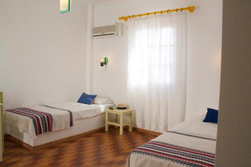 Postel nebo postele na pokoji v ubytování Arokaria Seaside