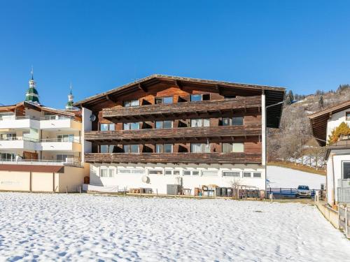 an apartment building with a snow covered ground at Brixen Alpin Living Top 7 in Brixen im Thale