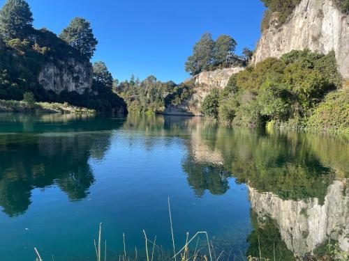 a river in the middle of a canyon at Sugar Cliff Vista Couples Retreat in Taupo