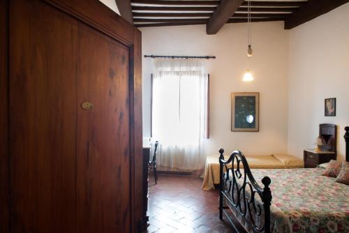 Letto o letti in una camera di Residenza D'Epoca Palazzo Buonaccorsi