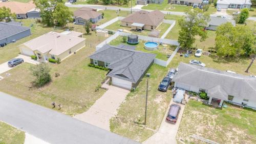 an aerial view of a house with a driveway at COZY home with fenced patio in Ocala