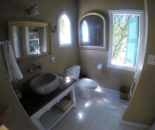 a bathroom with a sink and a toilet at Lowena Cottage in Tortola Island
