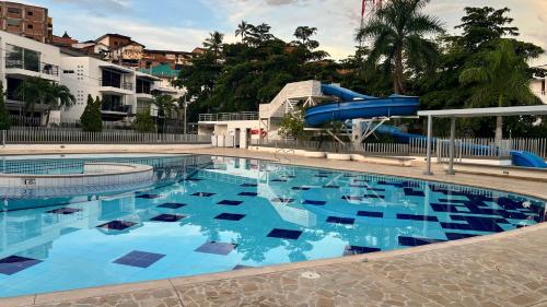 a large swimming pool with a water slide at Hermoso Apartasol!! cerca a Plaza Principal, Aire Acondicionado, Vista a la Piscina in Santa Fe de Antioquia