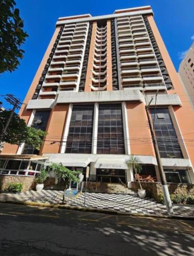 a tall building with a lot of windows at Apartamento Golden Beach Guarujá in Guarujá