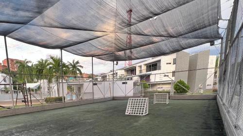 awning on a building with two white objects on a patio at Hermoso Apartasol!! cerca a Plaza Principal, Aire Acondicionado, Vista a la Piscina in Santa Fe de Antioquia