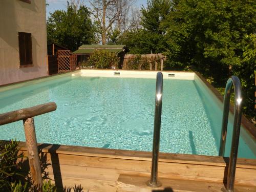 a large swimming pool with two metal poles in it at Agriturismo Ca' di Mazza in Monzuno