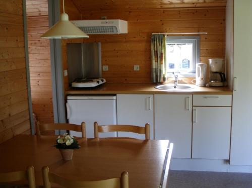 a small kitchen with a table and a sink at Vejle City Camping in Vejle