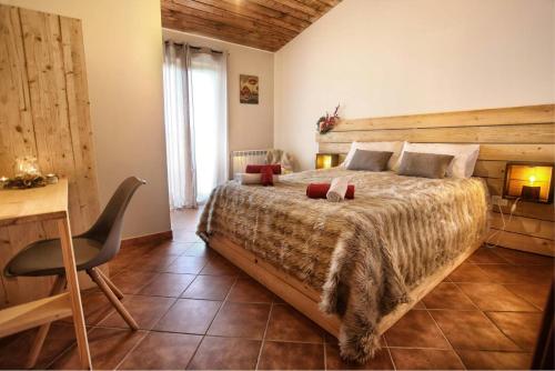 a bedroom with a large bed and a desk at Mountain Retreat With View Of Aeolian Islands in San Marco dʼAlunzio