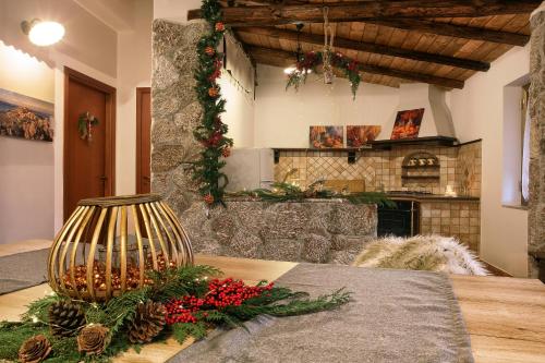 a kitchen with a table with christmas decorations on it at Mountain Retreat With View Of Aeolian Islands in San Marco dʼAlunzio
