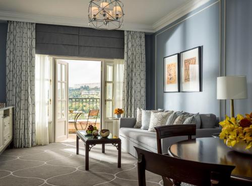 a living room with a couch and a table at Four Seasons Hotel The Westcliff in Johannesburg