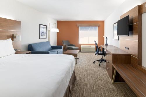 a hotel room with a bed and a desk at Holiday Inn Express & Suites Las Vegas SW Springvalley by IHG in Las Vegas