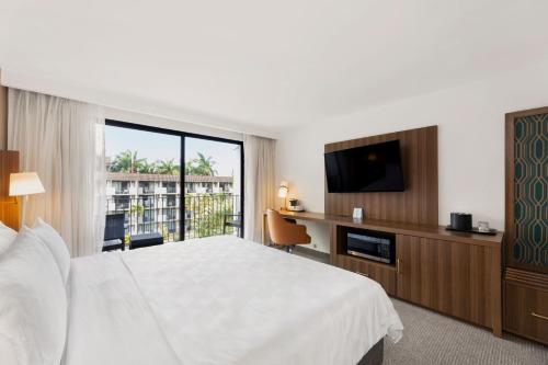 a hotel room with a bed and a flat screen tv at Holiday Inn San Jose La Sabana by IHG in San José