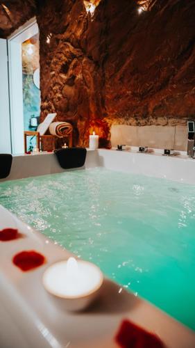 a bathroom with a tub filled with green water at Wellness Paradise mit Whirlpool in Bochum