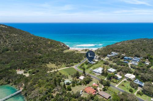 an aerial view of a road near the ocean at Korogoro Beach House in Hat Head