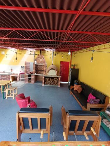 a living room with couches and tables in a room at Casa Alojamiento Tocllaraju in Tarica