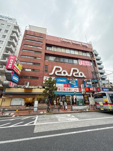 a building with a sign on the side of it at Eims stay Oomori304 in Tokyo