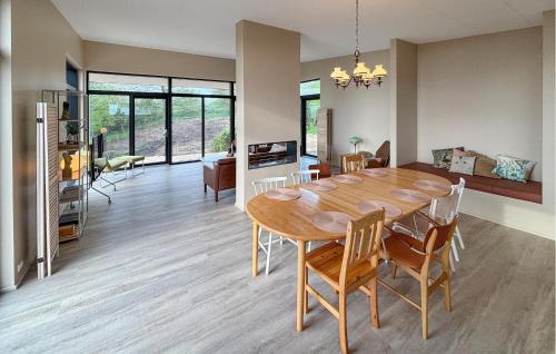 a dining room and living room with a table and chairs at 5 Bedroom Lovely Home In Lemvig in Lemvig