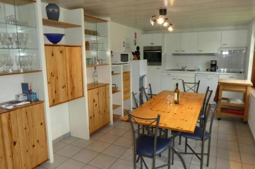 a kitchen with a wooden table and chairs at Zeewind Ii 278 in Bredene