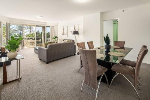 a living room with a table and a couch at Xanadu Escape - Seaside Resort near Surfers Paradise in Gold Coast