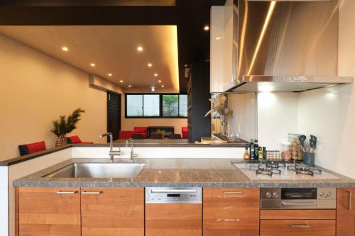 a kitchen with a sink and a counter top at Préciosité Chigasaki in Chigasaki