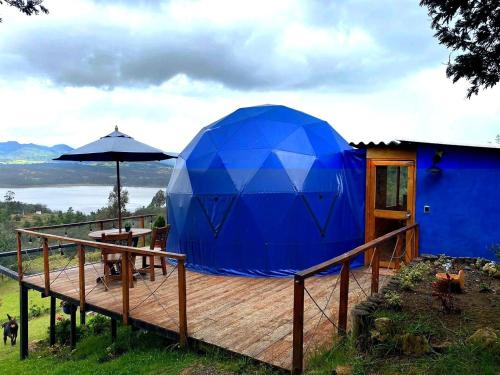 a blue dome tent on a wooden deck at Glamping blue. in Guatavita