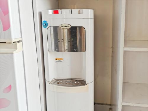 a small white appliance sitting next to a wall at Cozy 2BR Springlake Apt Bekasi with Pool & Gym by 2ndHome in Rawabugel