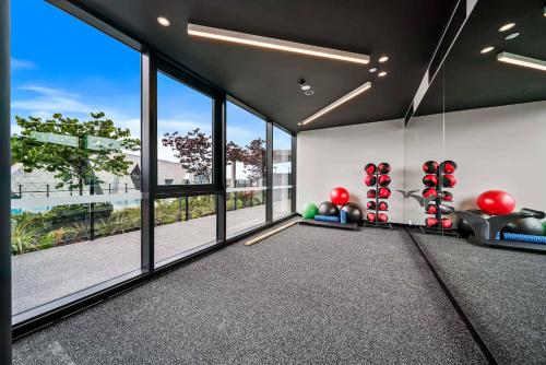 an empty gym with large windows and balls at Luxury Perth CBD Apartment with Pool & Gym - Sleeps 3 in Perth