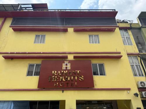 a yellow building with a sign for a hotel at Radiant Heights Hotel by KK Inn in Ampang