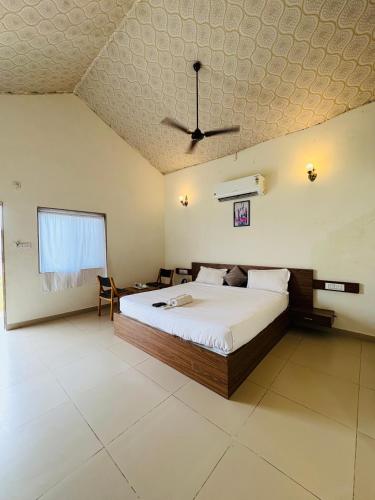 a bedroom with a bed and a ceiling at Unity Sunrise Resort Best Hotel Near Statue of Unity in Kevadia
