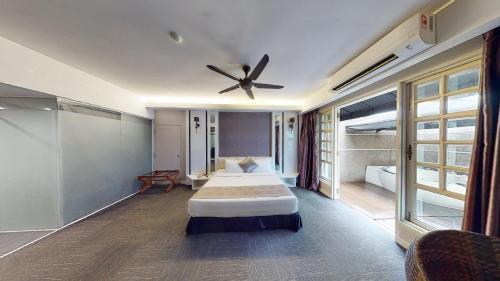 a bedroom with two beds and a ceiling fan at The Sterling Boutique Hotel Melaka in Melaka
