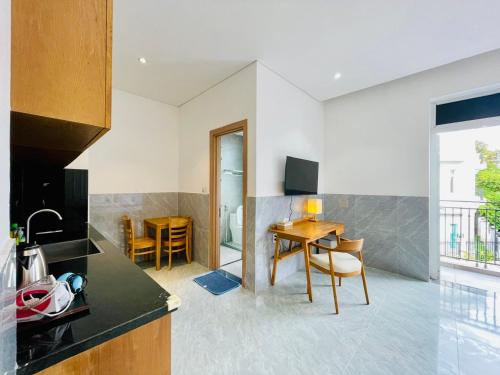 a kitchen with a table and a dining room at Tropical Mango House in Da Nang