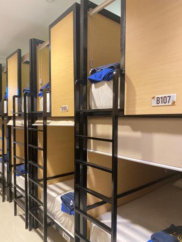 a row of bunk beds in a dorm room at Madina Inn Hotel in Sentool
