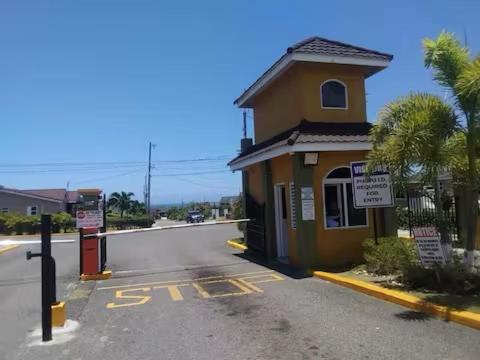 a small yellow building on the side of a street at Chateau Bellview in Falmouth