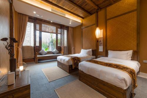 Postel nebo postele na pokoji v ubytování Ganzhou Banjiangxia Homestay