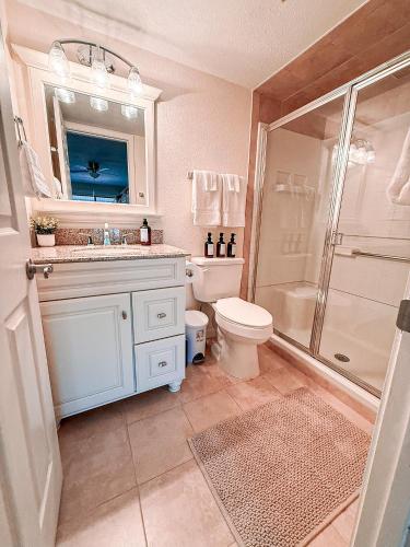 a bathroom with a toilet and a sink and a shower at Putters Paradise-2bed2bathgrillfirepit-10pp in Osage Beach